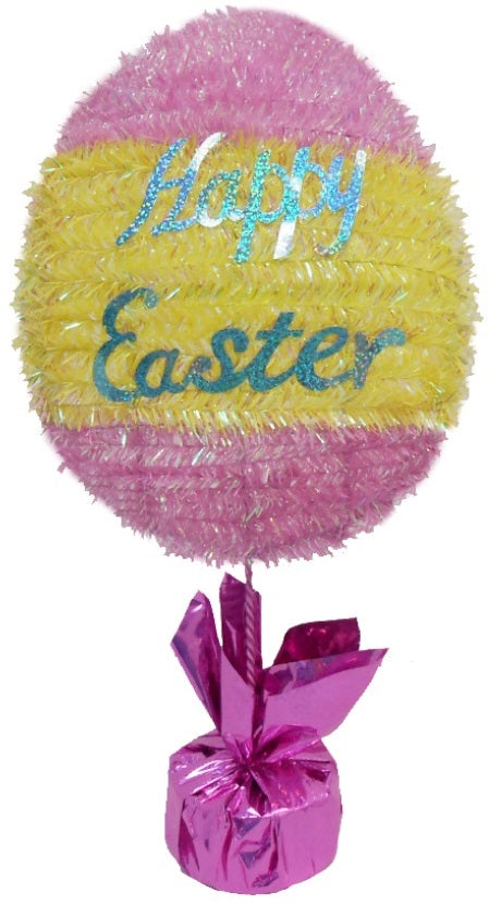 A tinsel tabletop decoration for Easter. It's pink and yellow. The text is a shiny blue color and it reads "Happy Easter"