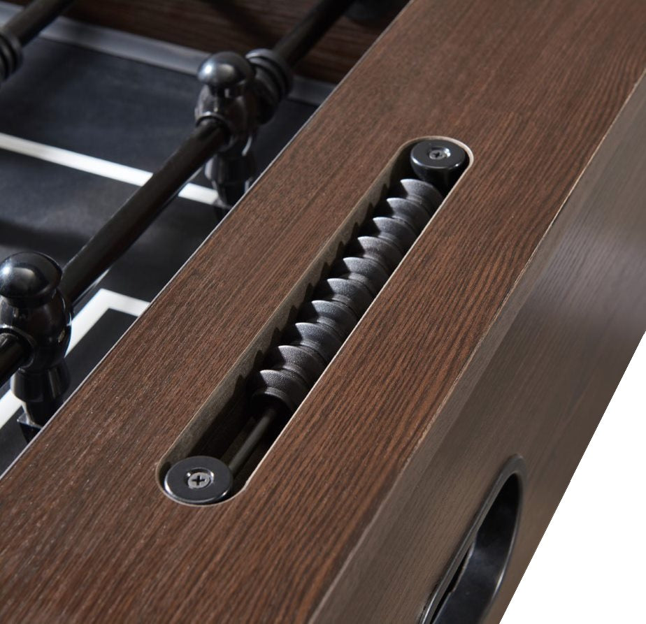 Close up picture of the black scoring system for the foosball table inside of the dark brown frame.