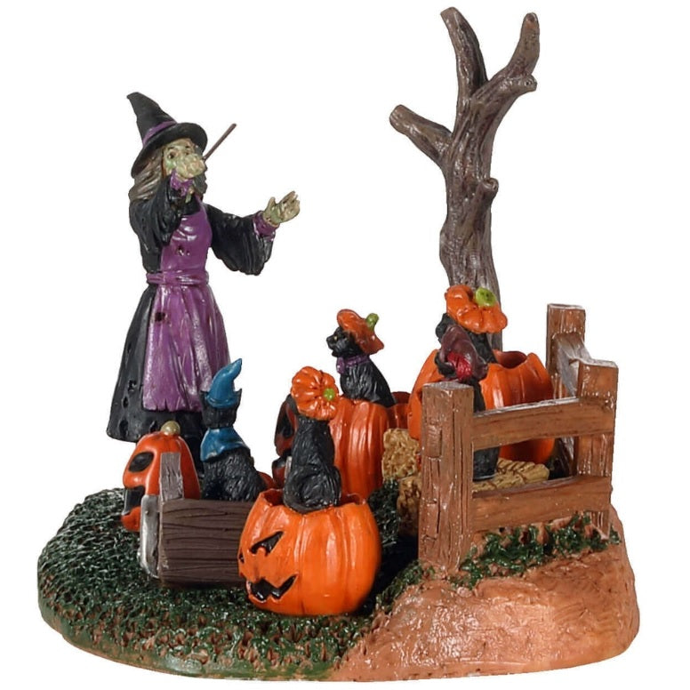 Polyresin village accent for a Lemax display. Designed to look like a witch conducting a chorus of black cats sitting on pumpkins and bales of hay.