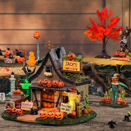 Polyresin building for a Lemax display. Designed to look like a spooky cottage on a pumpkin farm. There's a red truck on the side near a tree with a sign on it that reads "CREEPY CORN MAZE!" There's a scarecrow with crows sitting on it. There's another sign that reads "PICK AT YOUR OWN RISK!"