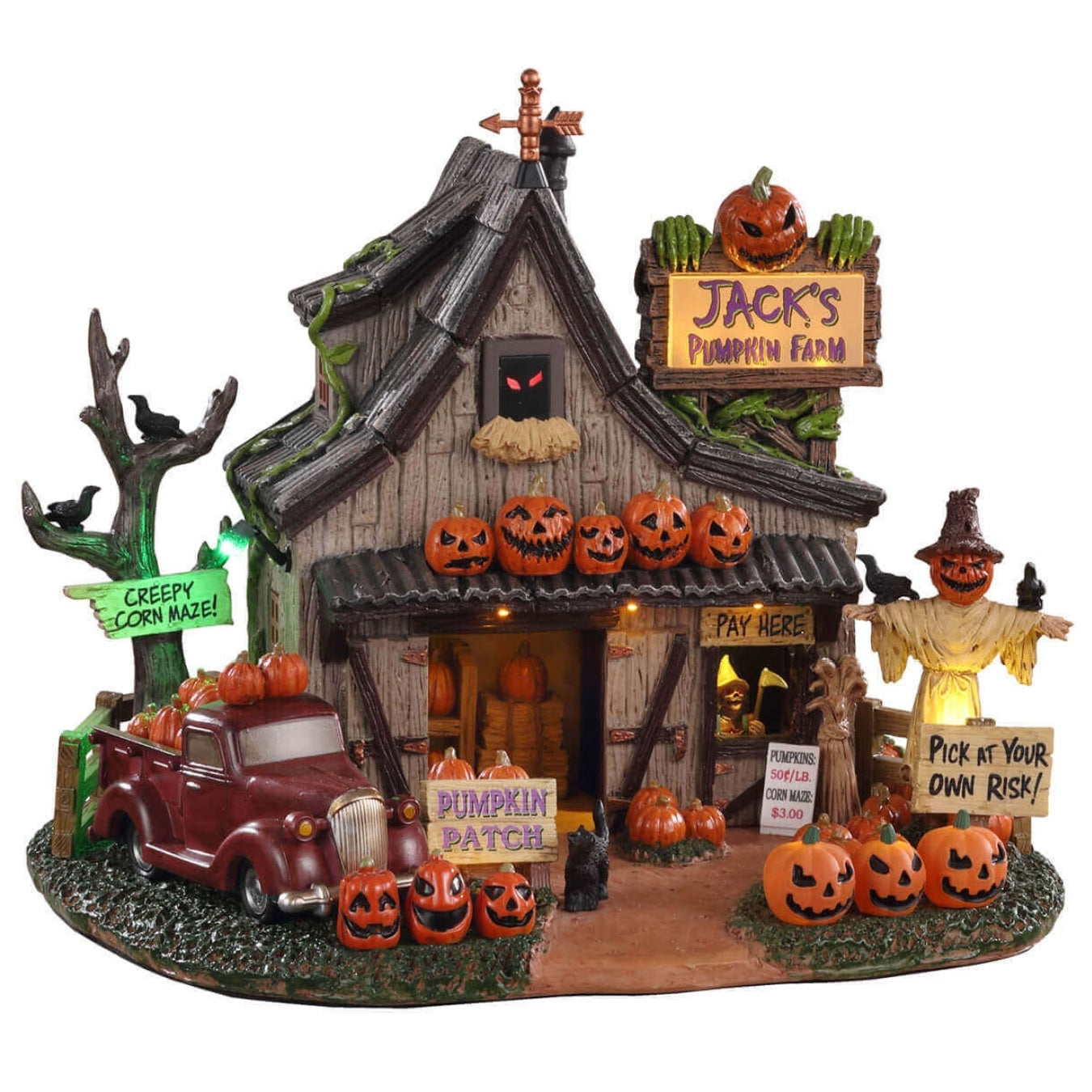 Polyresin building for a Lemax display. Designed to look like a spooky cottage on a pumpkin farm. There's a red truck on the side near a tree with a sign on it that reads "CREEPY CORN MAZE!" There's a scarecrow with crows sitting on it. There's another sign that reads "PICK AT YOUR OWN RISK!"