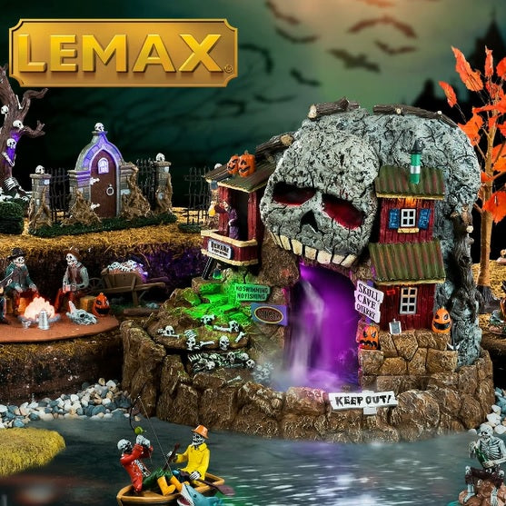 Polyresin village accent for a Lemax display. Designed to look like a rock quarry cave. The top of the cave is designed to look like the top of a skull with glowing red eyes. There are bones and skeletons and pumpkins and a sign that reads "KEEP OUT!" Inside the cave there's a purple fog and you can very faintly see skeletons.