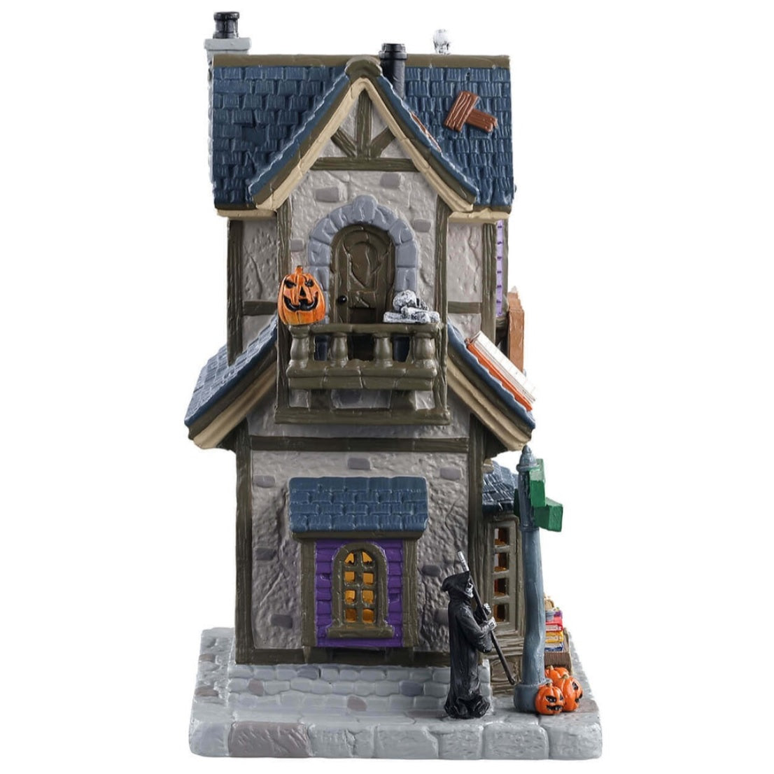 Porcelain lighted building for a Lemax display. Designed to look like a house that's been turned into a bookstore. There are skeletons reading, a Grim Reaper on the sidewalk and a shelf of books for sale outside.