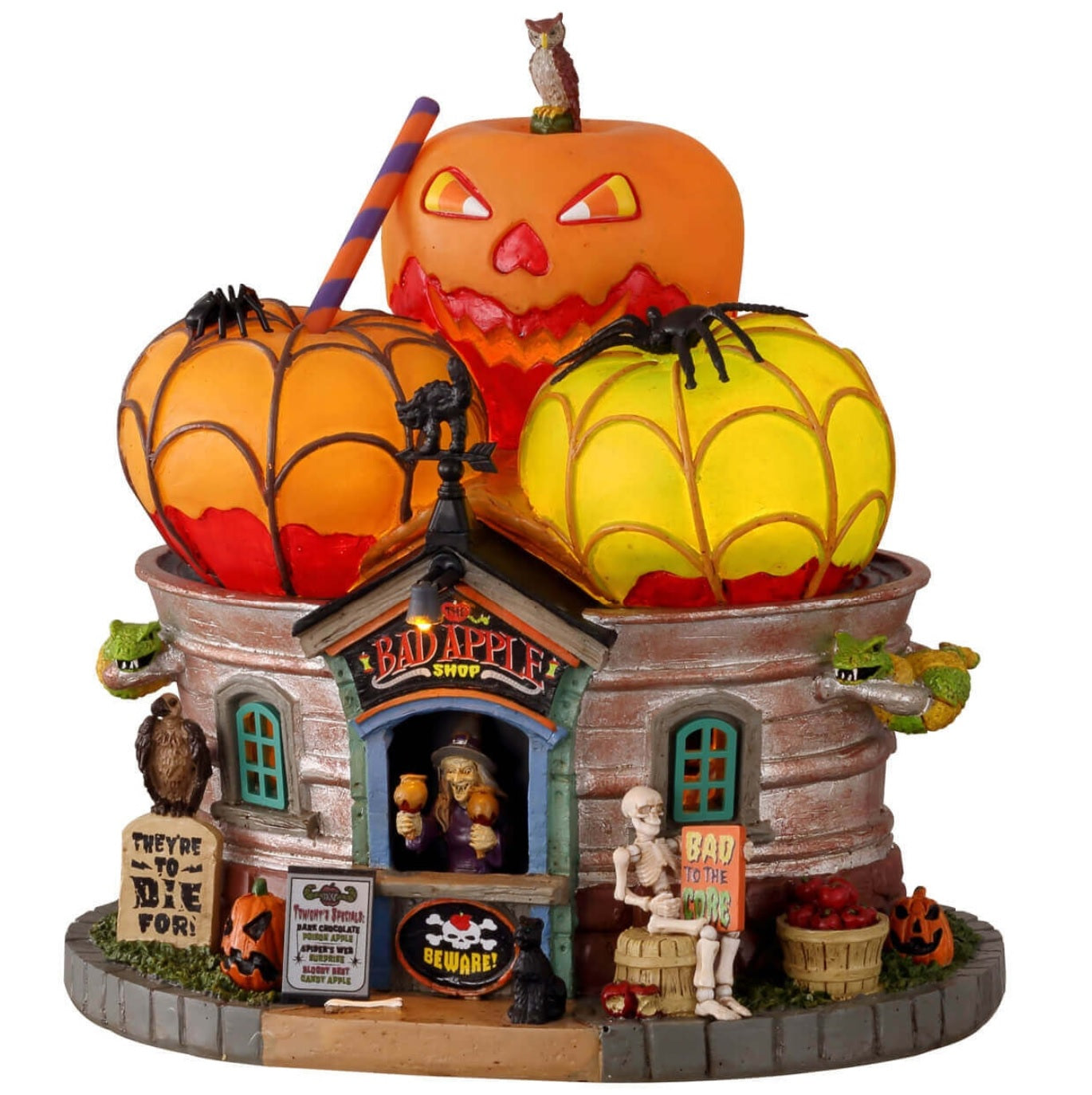 Polyresin building for a Lemax display. Designed to look like a building with a roof made out of giant apples. There's a witch at the front booth handing out caramel covered apples. There are snakes, owls, black cats, tombstones, a skeleton sitting on a barrel and a barrel of apples.
