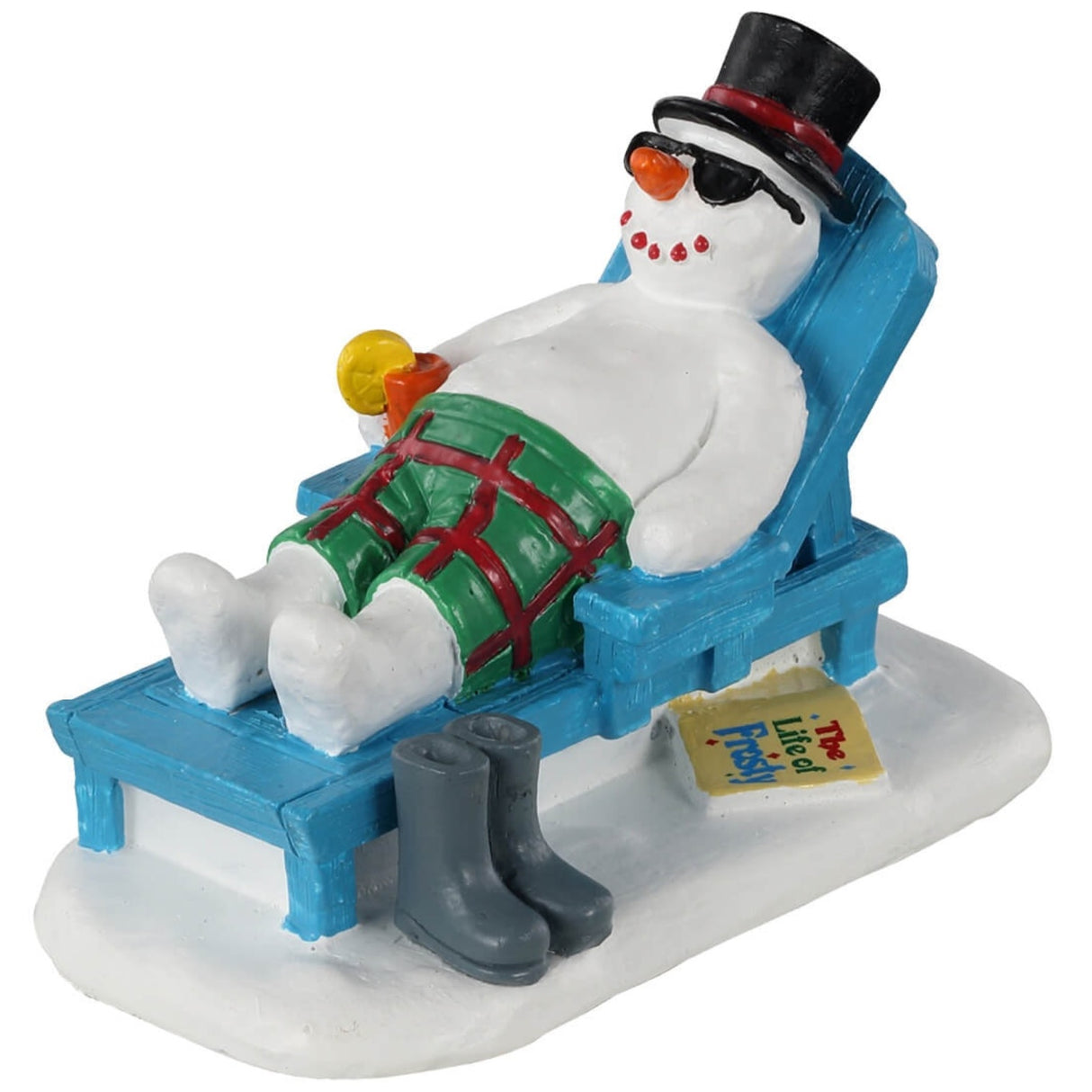Polyresin figurine for a Lemax Village display. Designed to look like a snowman resting on a lounge chair. He is wearing a top hat, sunglasses and green and red shorts. He's holding a drink in one hand. His boots are off to the side of the chair. There's a book on the ground that reads "The Life of Frosty"