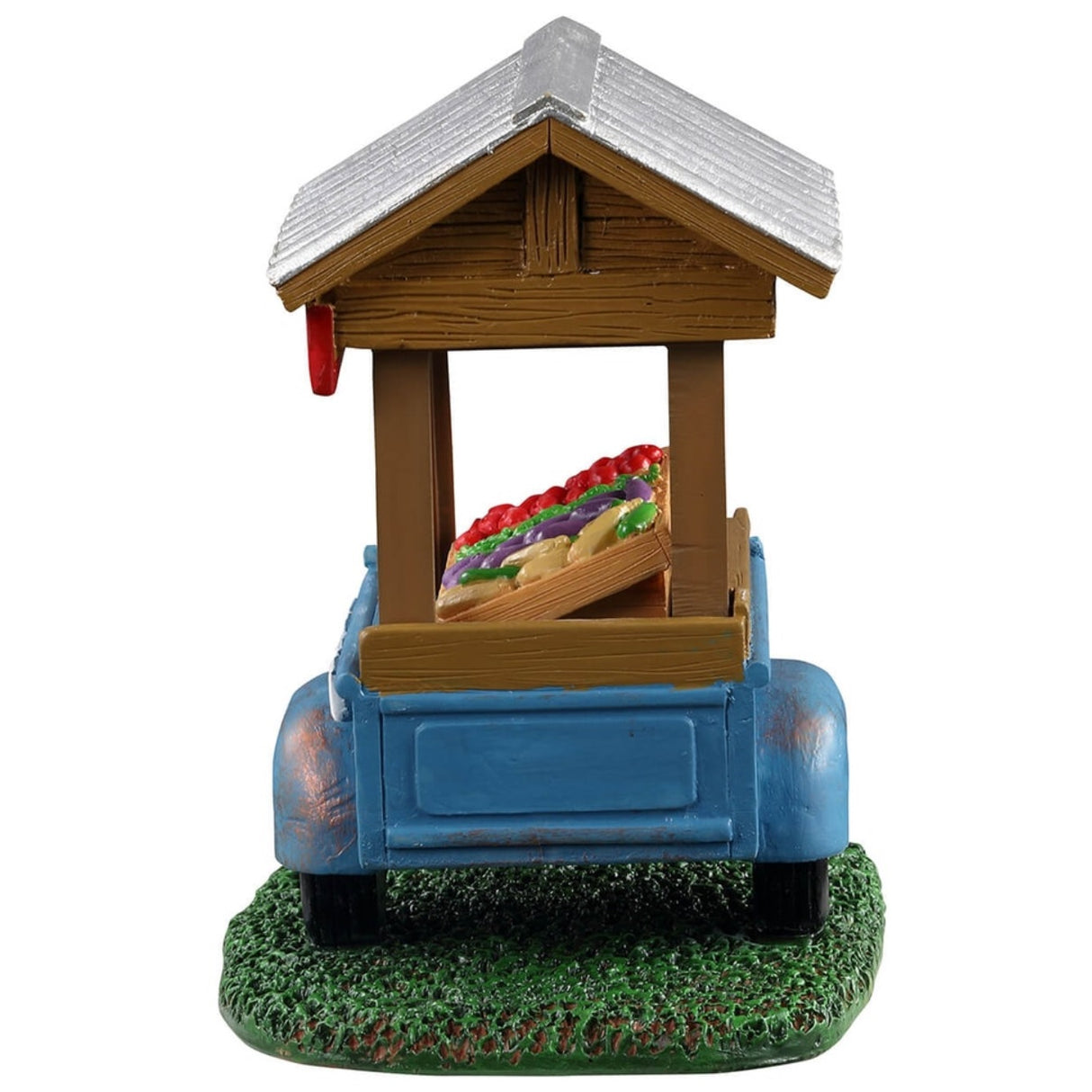 Polyresin figure for a Lemax display. Designed to look like a blue vegetable cart. There's a sign that reads "FARM FRESH" on the cart. Next to the cart, there's a sign on the ground that reads "Self serve honor system: If you don't have correct change, put in what you can... Settle up next time!" Inside the cart, there are tomatoes, green beans, eggplants and corn on the cob.