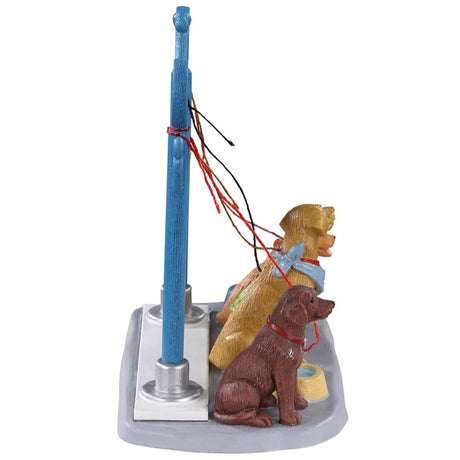 Polyresin figure for a Lemax display. Designed to look like a blue station for dogs to be tied up while their owners shop. The sign reads "Deluxe Dog Parking" and there are four dogs waiting patiently for their owners to return. There are two bowls of water on the ground.