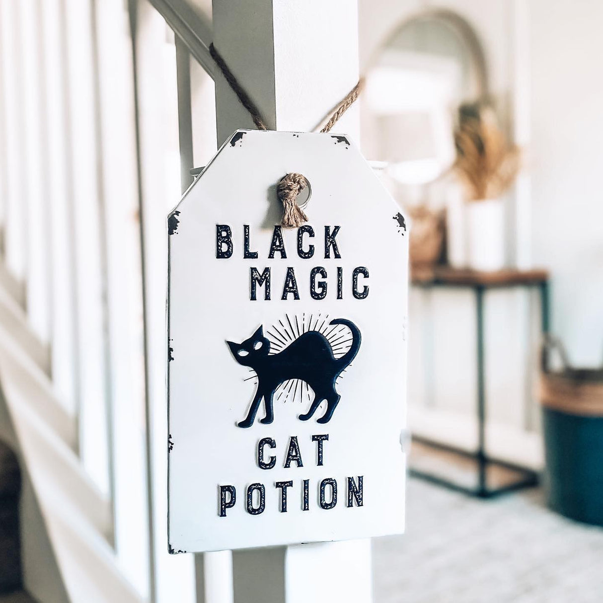 Halloween hanging decoration shaped like a gift tag. One reads "Witch's Brew." One reads "Bat Wing Tonic Elixir." One reads "Arsenic Poison. Do not drink." One reads "Black Magic Cat Potion."