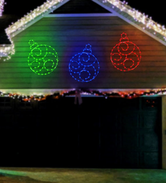A house decorated with three decorative, LED ornaments.