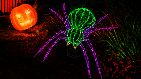 Twinkling LED outdoor decoration for Halloween. Shaped like a giant green and purple spider.