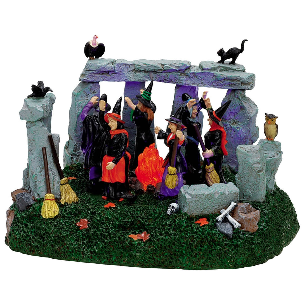 Polyresin village accent for a Lemax display. Designed to look like a group of witches gathering in a cemetery with a stone fence around them. There are broomsticks and leaves and bones on the ground and a crow, a vulture, a black cat and an owl on the fence.