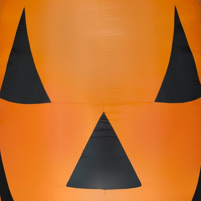 Very large, very bright inflatable shaped like a jack-o-lantern.