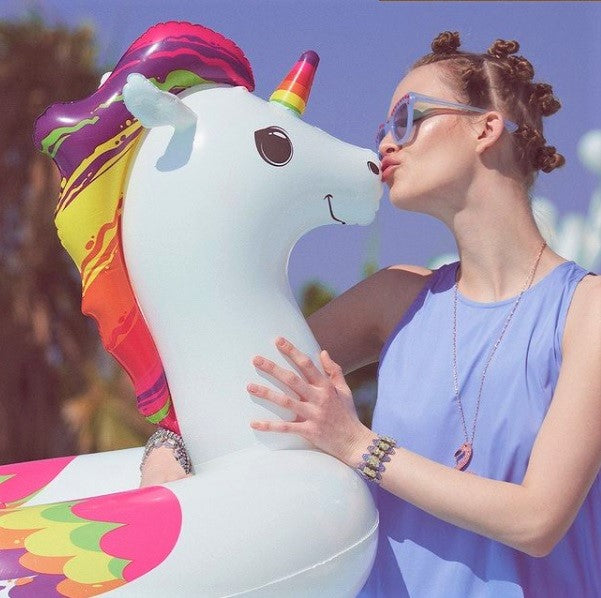 Inner tube for kids shaped like a rainbow, unicorn.