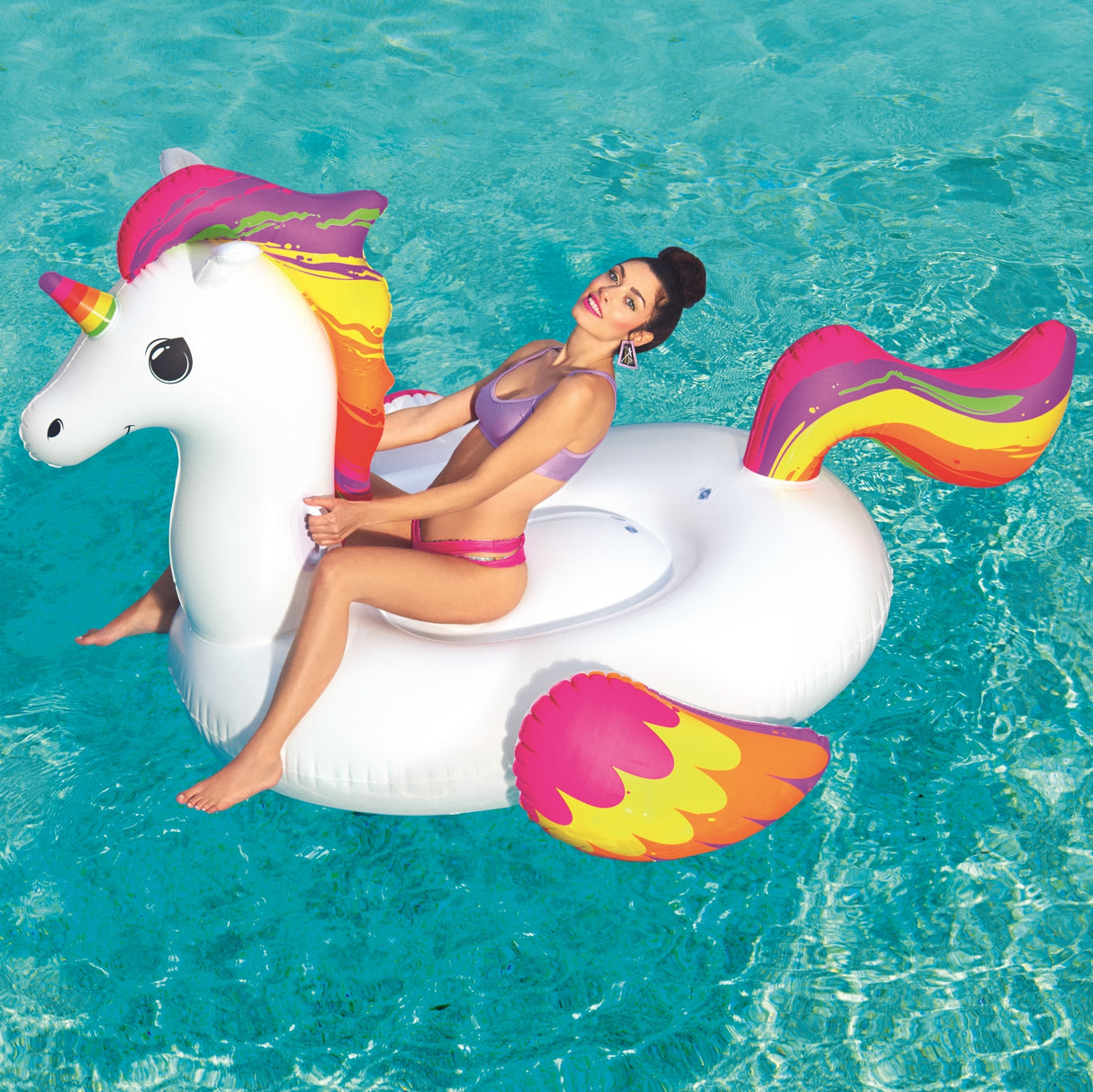 Inflatable pool float shaped like a white and rainbow unicorn.