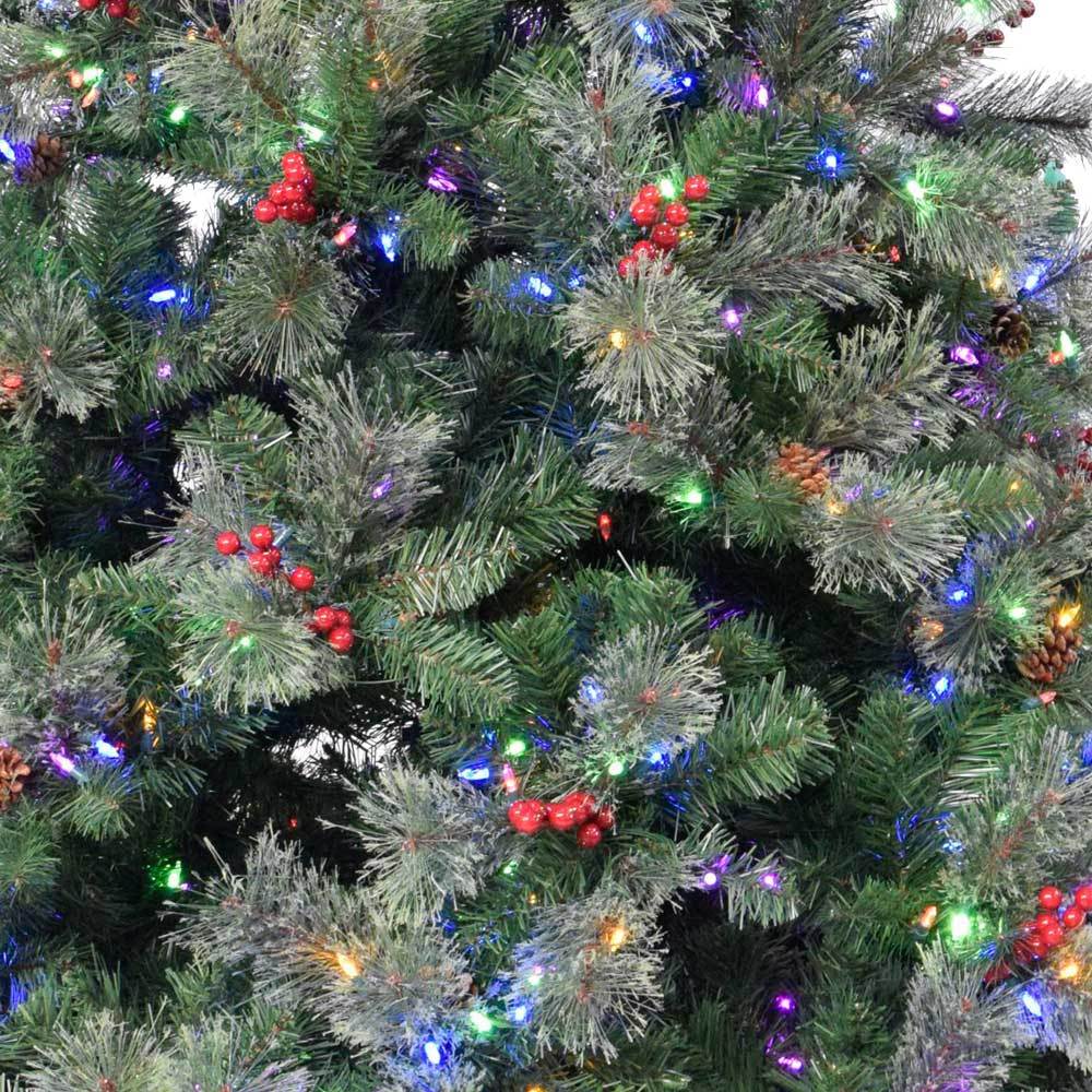 Artificial tree pre-lit with dual lights. Lights change from clear to multi-colored lights. The tree also features red berries and white glitter.