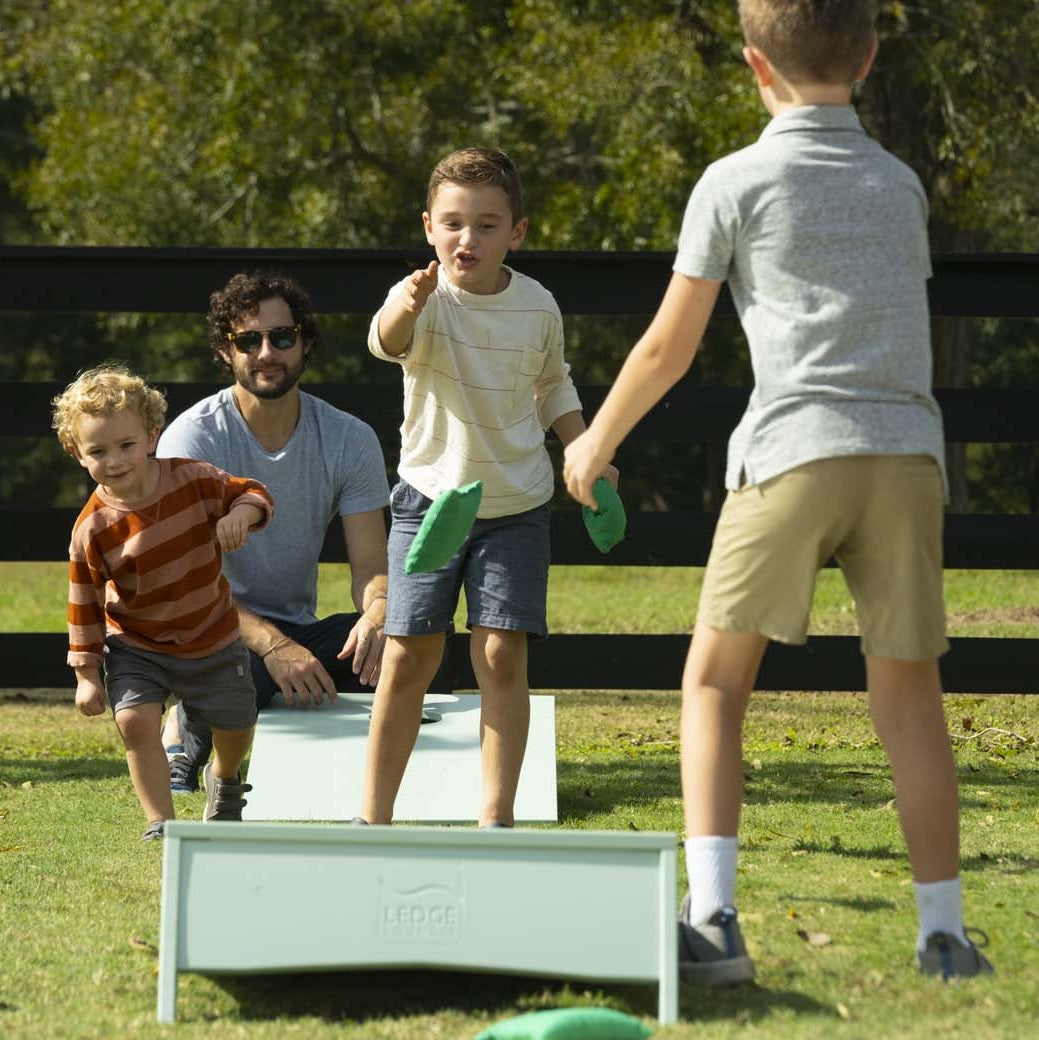 Family playing bag toss