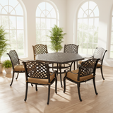This is a lifestyle image showing this cushioned aluminum dining collection inside a nice room with lots of windows and plants.