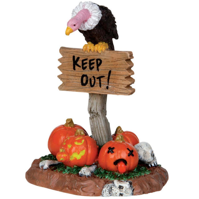 Resin figurine for a Lemax display. Designed to look like a vulture standing on top of a wooden sign that reads "KEEP OUT!" There are carved pumpkins and skulls below it on the grass.