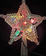 This image shows the iridescent beaded tree star with multi-colored lights.