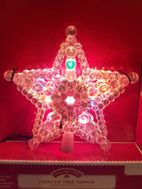 This image shows the multi-colored tree topper all lit up.