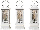 White lantern decoration with glitter and a woodland scene with a cardinal inside.