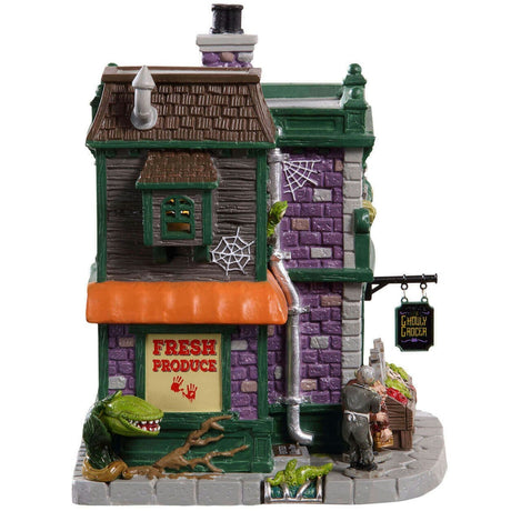 Porcelain lighted building for a Lemax display. Designed to look like a brick grocery store. There are monsters at the front door and boxes of stuff you can buy near the front window. Inside the window, you can see some creepy crawlies hanging from hooks. There are carved pumpkins on the roof.