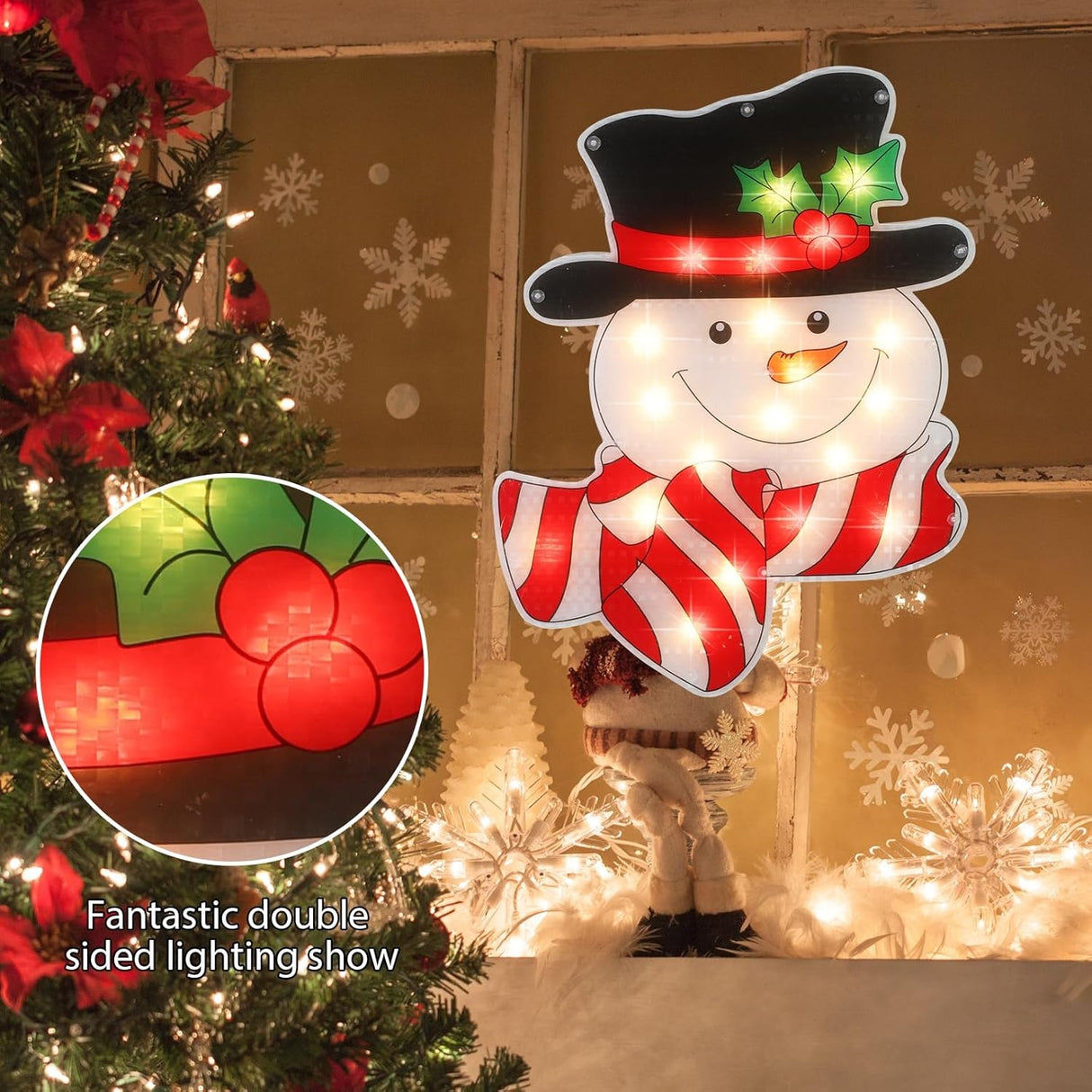Pre-lit decoration shaped like a smiling snowman wearing a black top hat with holly leaves and berries and a red and white striped scarf.