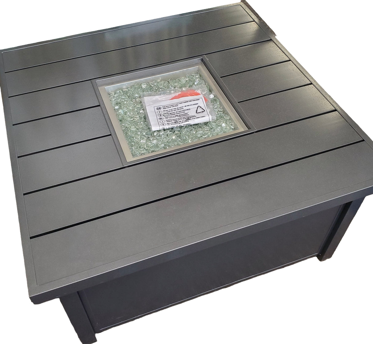 This image shows what this fire pit table looks like on a white background. The lid is off.