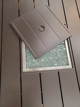 This image shows what the top of the fire pit table looks like. The top has slats on it. This image shows what the lid looks like off the table.