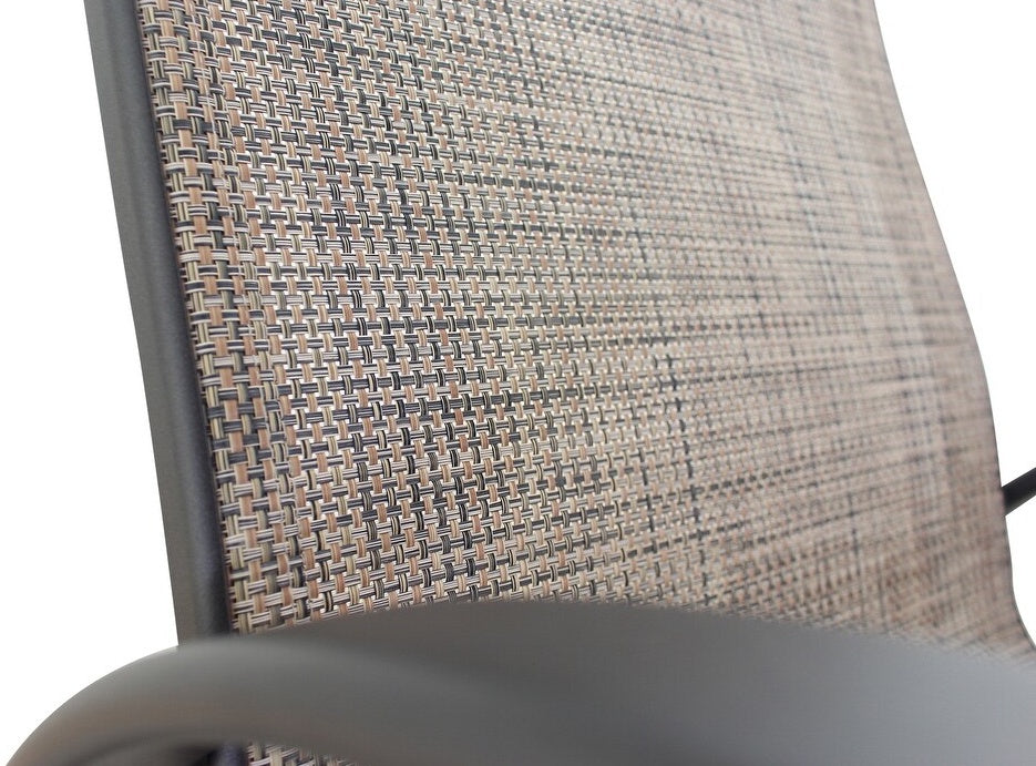 This is an up close view of the chair. The chair's frame is a dark brown color. The chair's sling is a mix of light brown and dark brown wicker.