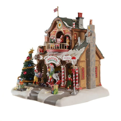 Polyresin lighted building for a Lemax display. Designed to look like Santa's workshop. Decorated for Christmas and with snow on the roof and sidewalk.