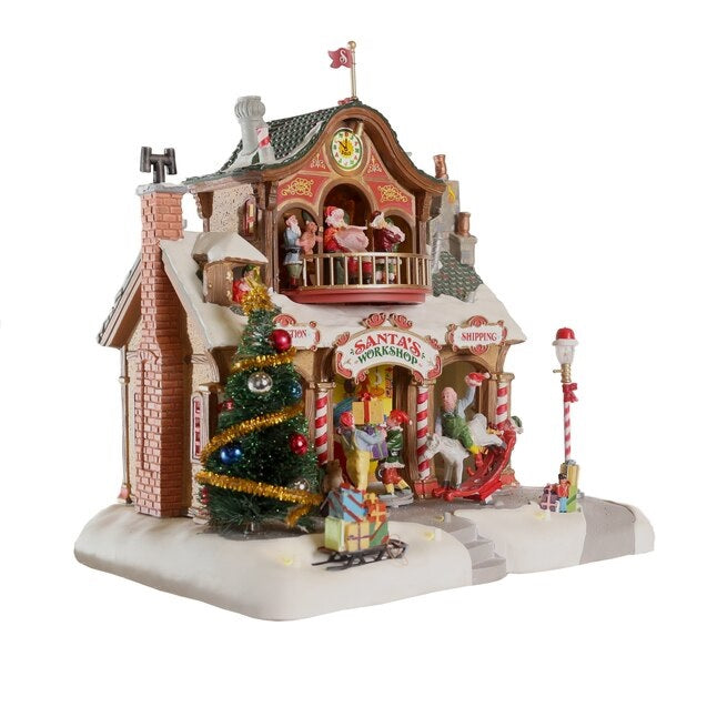 Polyresin lighted building for a Lemax display. Designed to look like Santa's workshop. Decorated for Christmas and with snow on the roof and sidewalk.