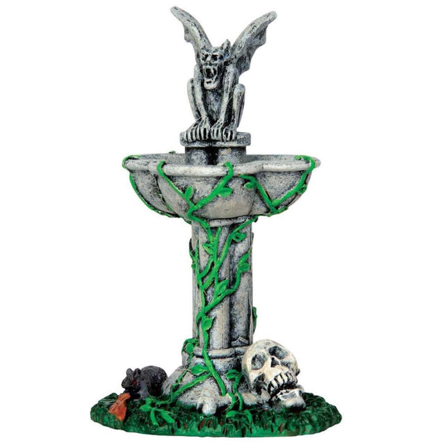 Polyresin figurine for a Lemax display. Designed to look like a fountain with vines growing on it. In the middle of the fountain is a statue of a gargoyle. There's a rat in the grass and a skull.