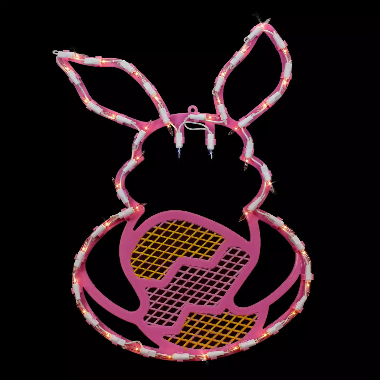 A pink window silhouette decoration shaped like a bunny holding a yellow egg on a black background