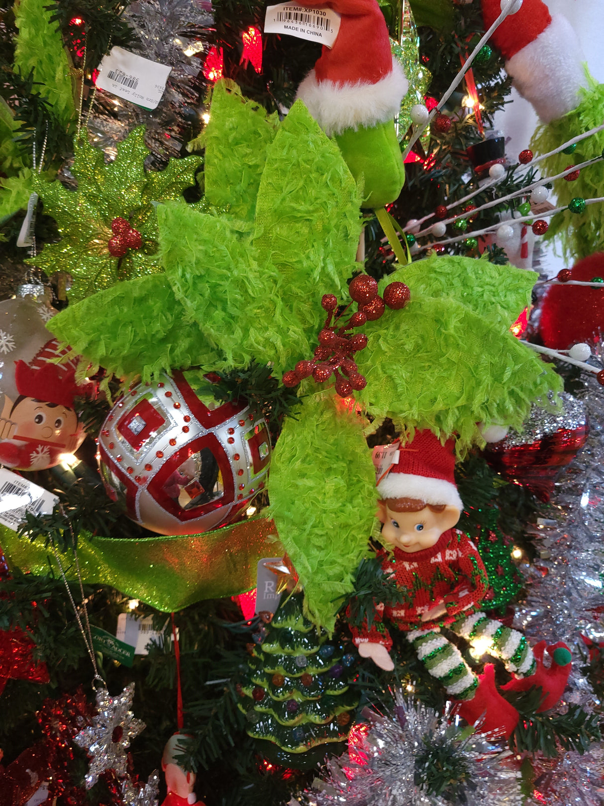 Furry lime green poinsettia-shaped flower pick with red glitter in the center.