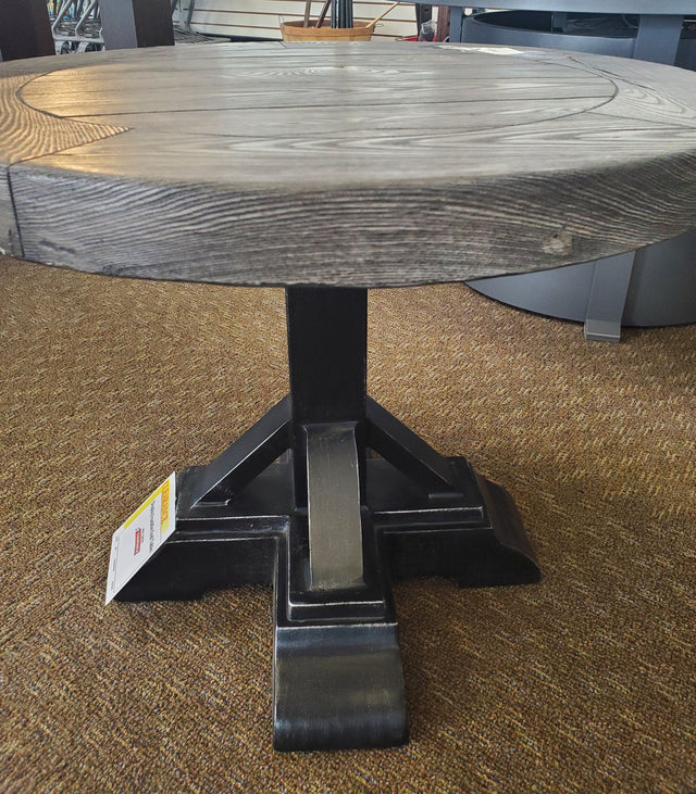 Round table with a gray woodgrain tabletop and black legs.
