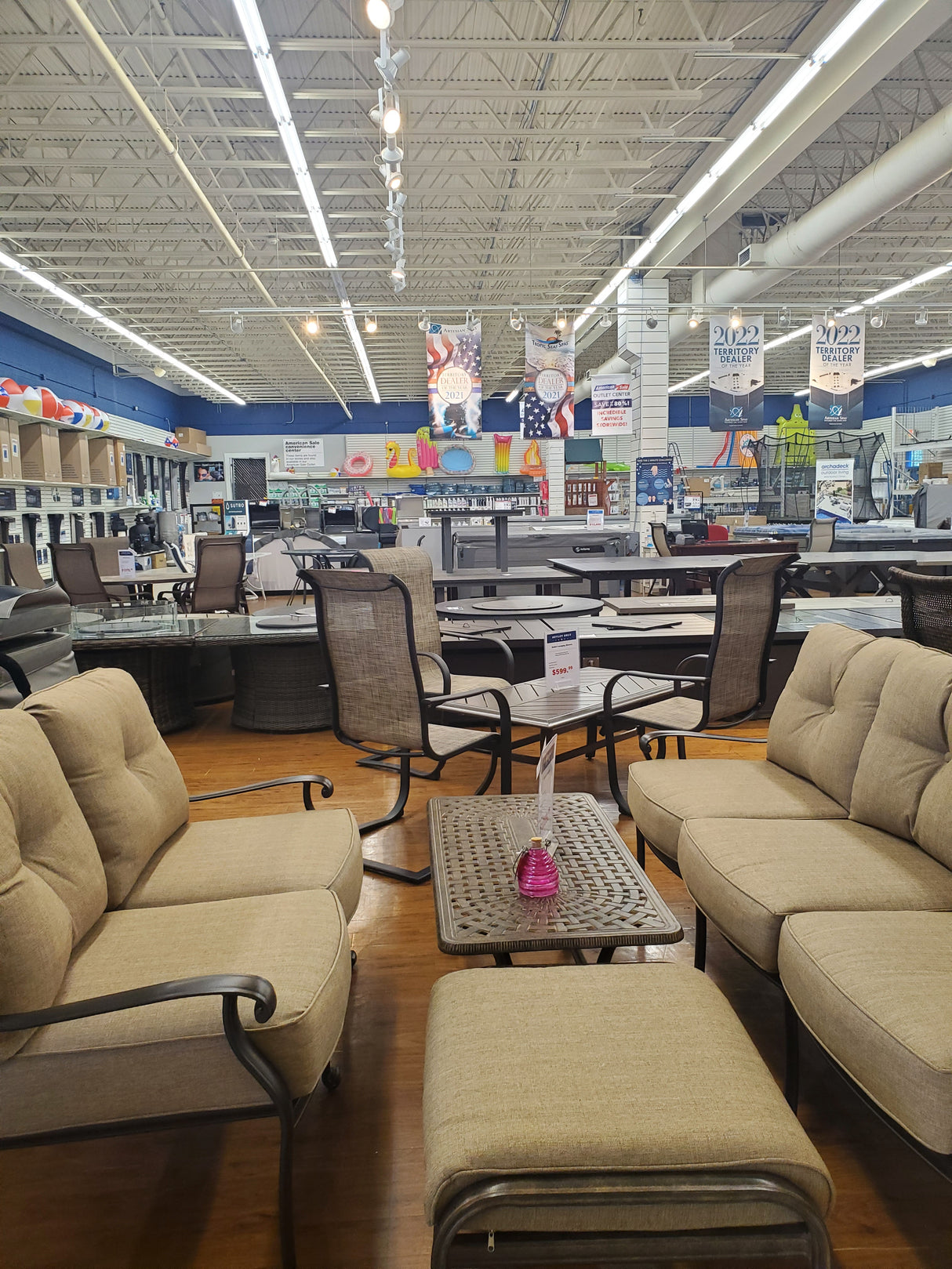Beige chairs in a store setting with various items on shelves.