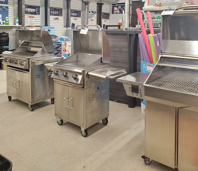 Various clearance BBQ grills on display in our Tinley Park Outlet store.