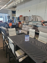 Clearance outdoor patio furniture sets on display in the Tinley Park Outlet store with various cushions .
