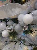 This is a lifestyle image showing this beaded garland wrapped around a tree along with other ribbons, ornaments and tinsel garland.