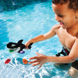 Pool game shaped like a whale whose mouth opens up. Kids try to use the whale's mouth to swallow up the little toy fish.