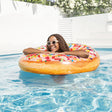 Inflatable inner tube designed to look like a donut with frosting and multi-colored sprinkles.