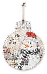 This wooden ornament reads "Warm Winter Wishes" and features a snowman wearing a Santa hat and looking at a cardinal on a tree.