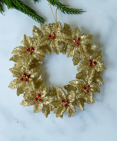 Gold glitter ornament shaped like a wreath with red berry accents.
