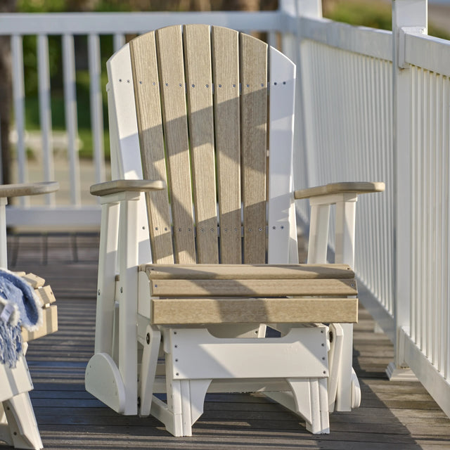 This is a lifestyle image showing the Birch and White colored Adirondack glider chair on a wooden porch.