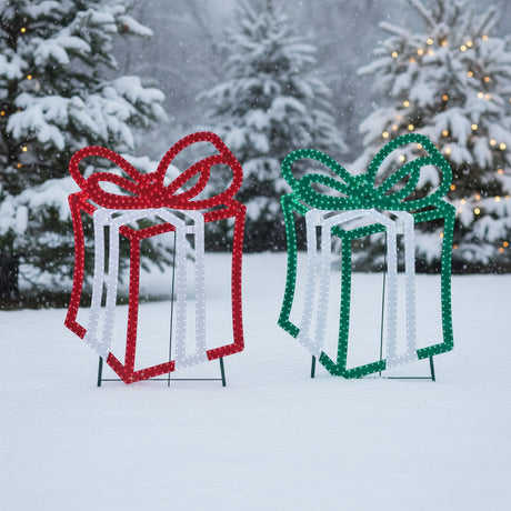 This is a lifestyle image showing the two different present decorations in a snowy yard.