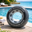 This is a lifestyle image showing the inner tube on the edge of a pool. It's designed to look like a tire.