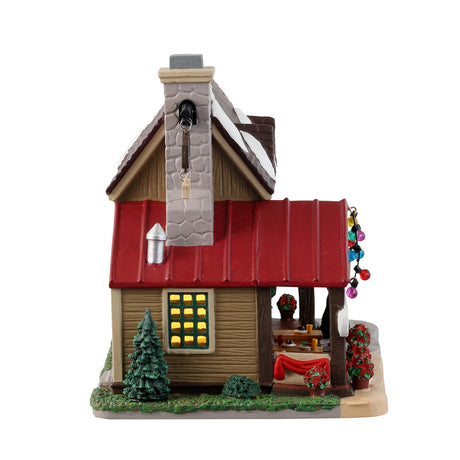 Porcelain lighted building for a Lemax Village display. Designed to look like a brown house with a stone chimney.