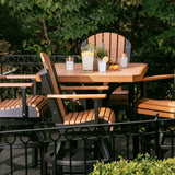 This is a lifestyle image showing the Cedar and Black colored square table surrounded by matching benches. 