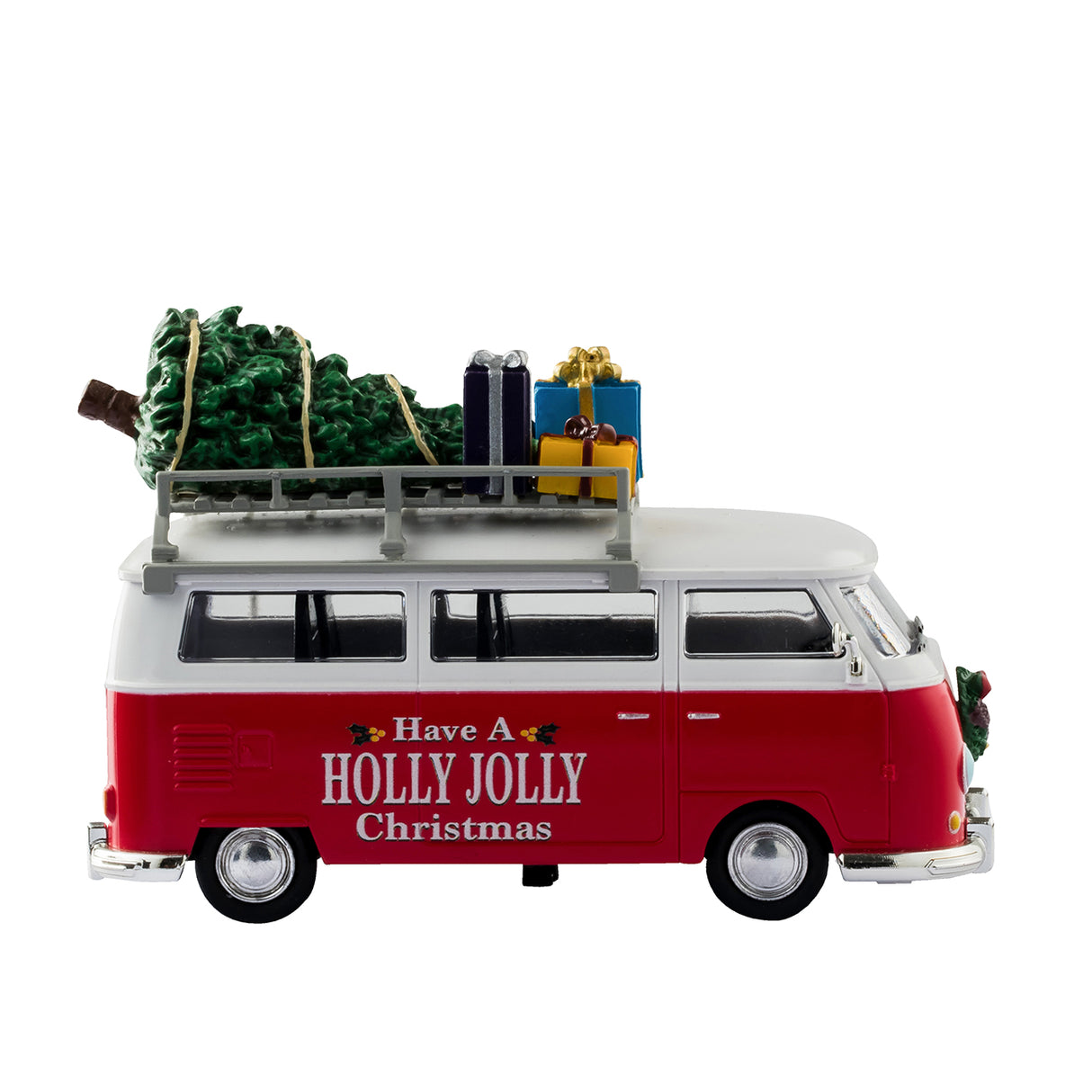 Plastic table accent for a Lemax display. Designed to look like a red and white Volkswagen bus. The sides read "Have a Holly Jolly Christmas" and features little holly leaves and berries. There's a decorated wreath on the front bumper. There's a ladder on the side that leads up to the roof of the van where there's a collection of presents and a Christmas tree.